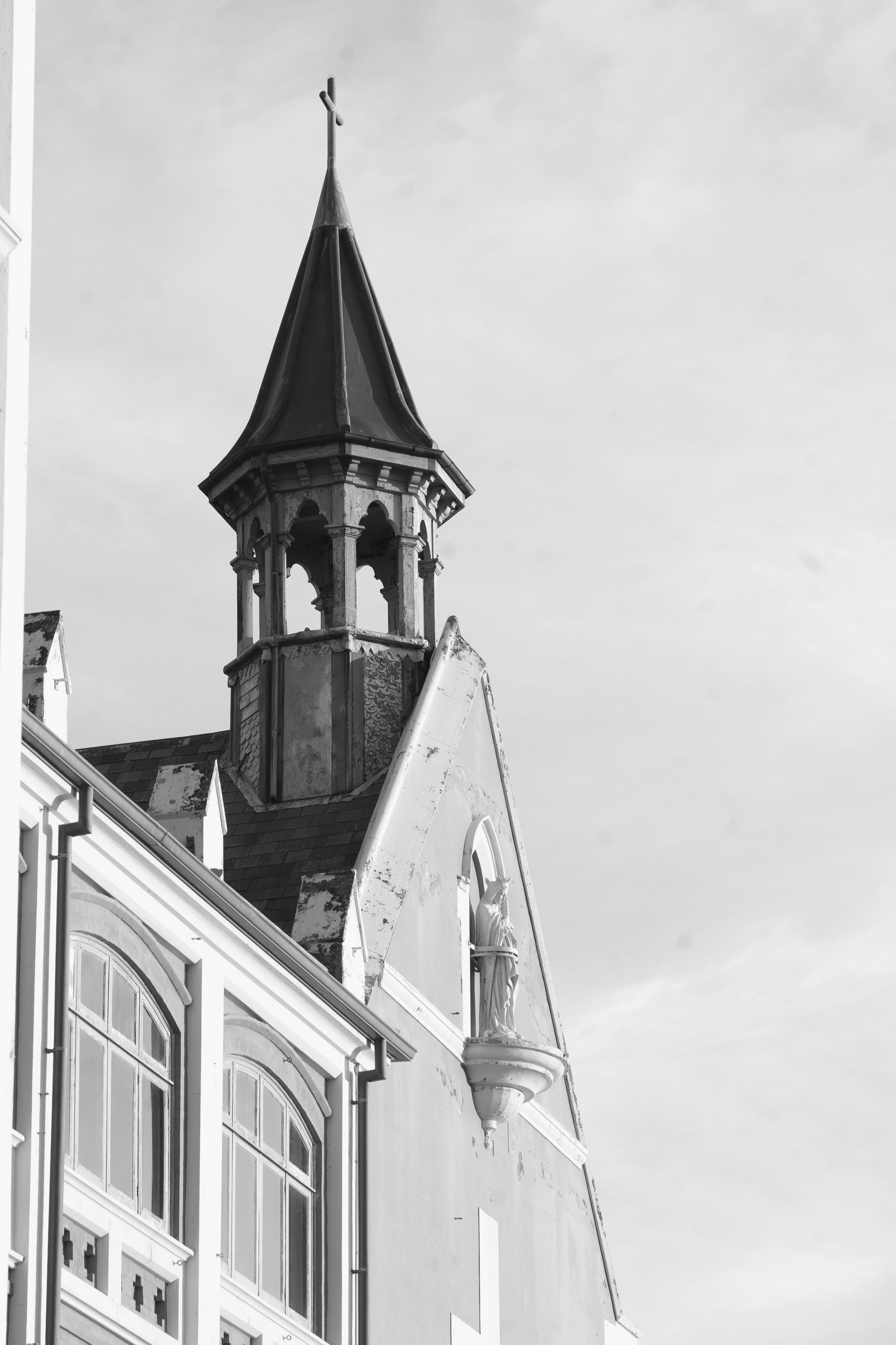 A black and white view of a church steeple.