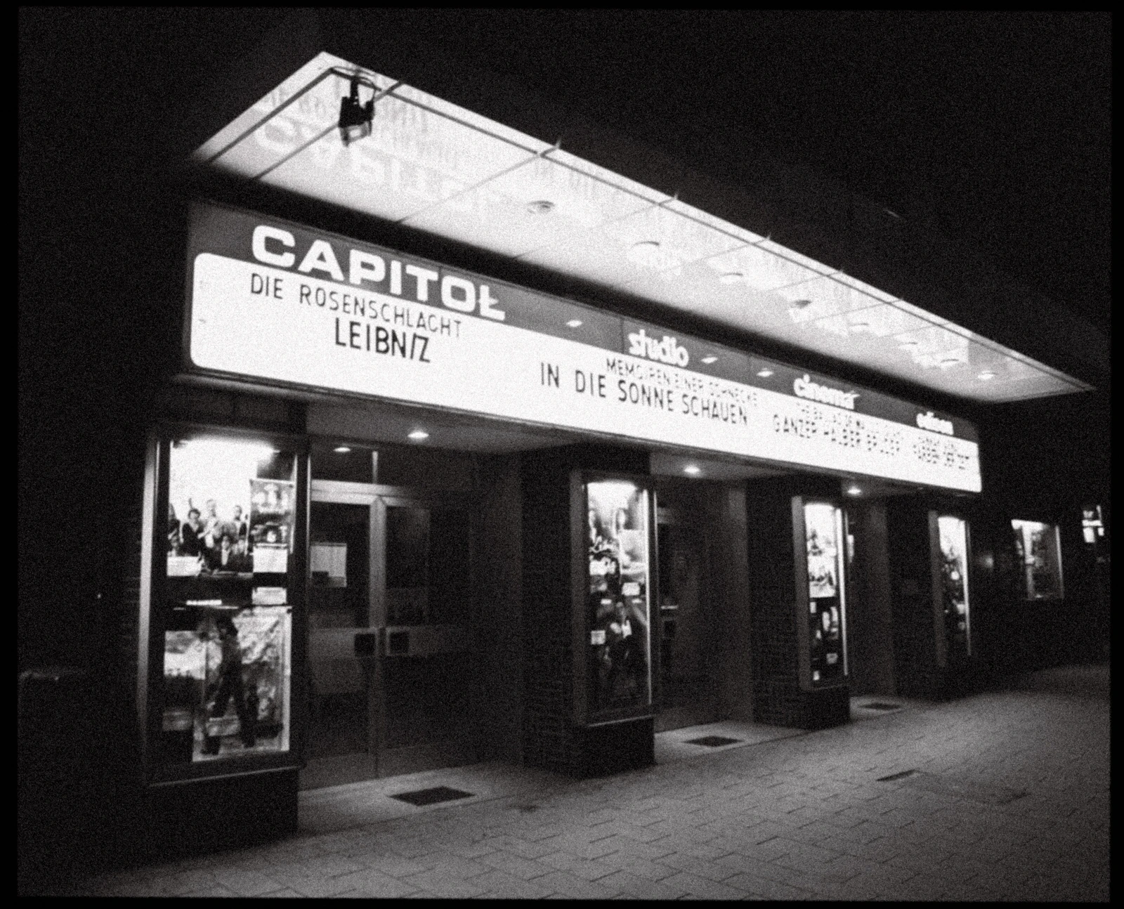 A heritage cinema entrance glowing at night