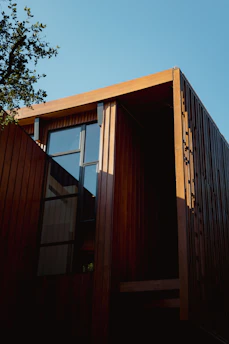 Modern wooden building with large windows against sky