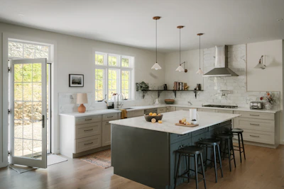 Modern kitchen with island and stainless steel appliances.