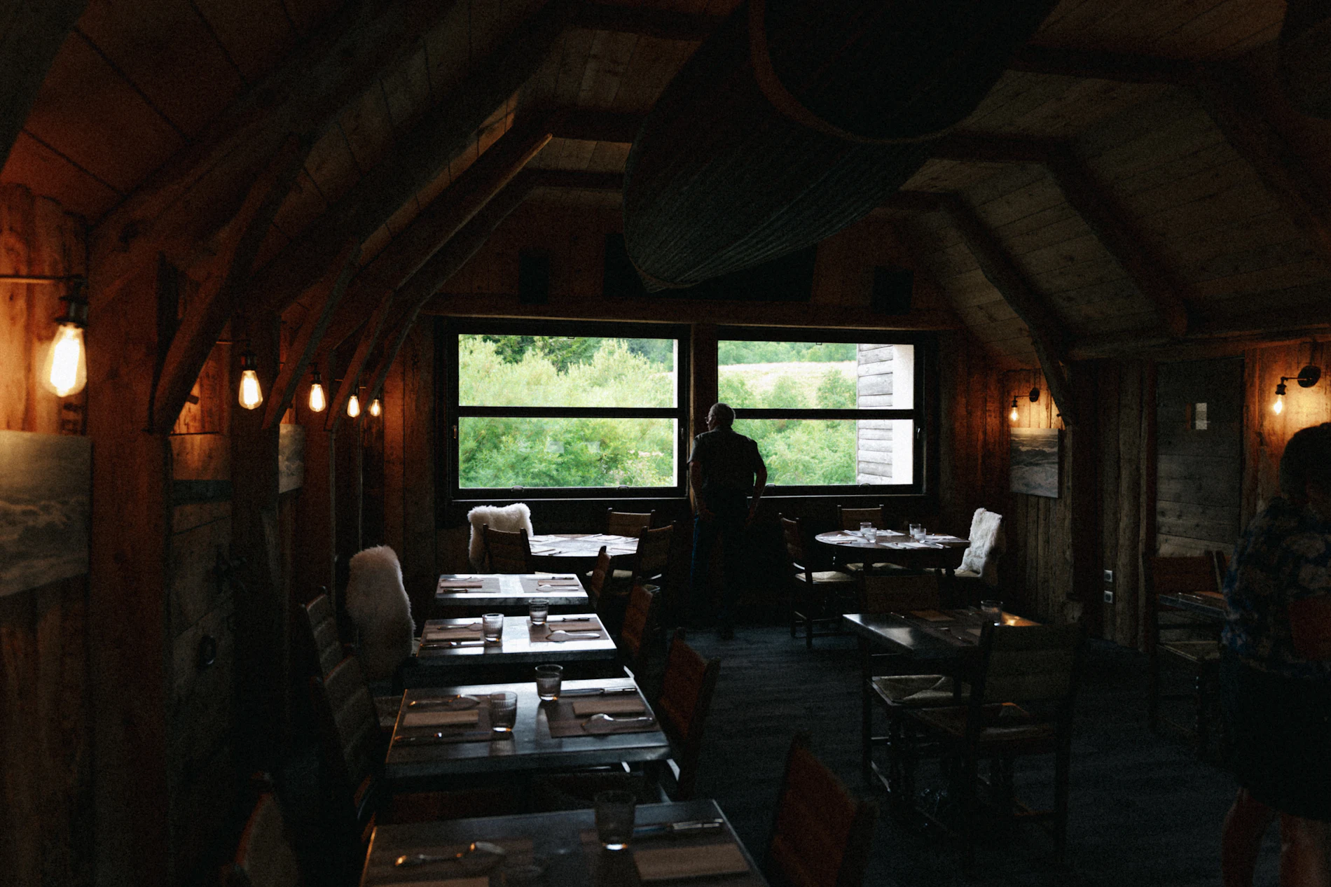 Salle à manger rustique et chaleureuse aux grandes fenêtres
