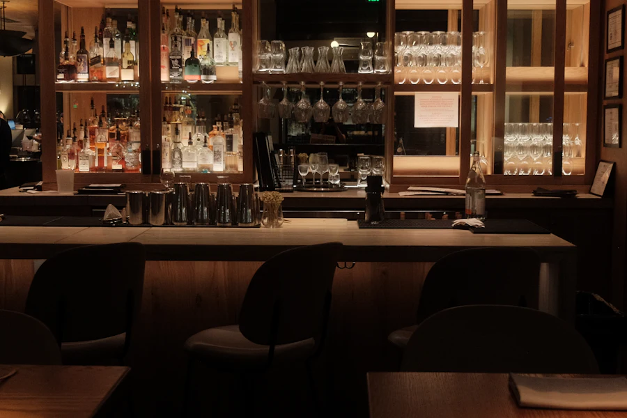 Bartender serving cocktails at a bar counter