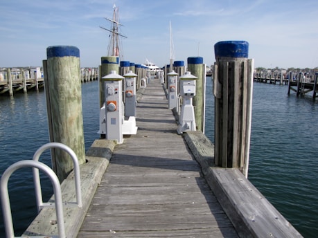 Wooden pier with boats docked in the harbor.