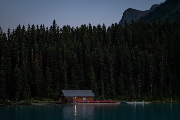 Wooden cabin beside a still lake — Kurt WANG on Unsplash