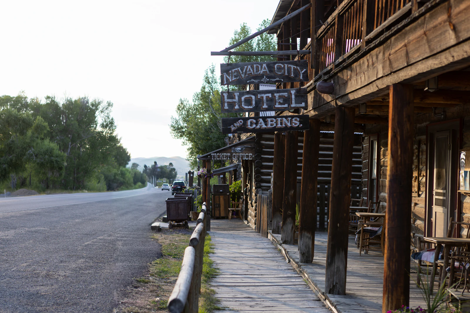 An old hotel and cabins along a wooden boardwalk.