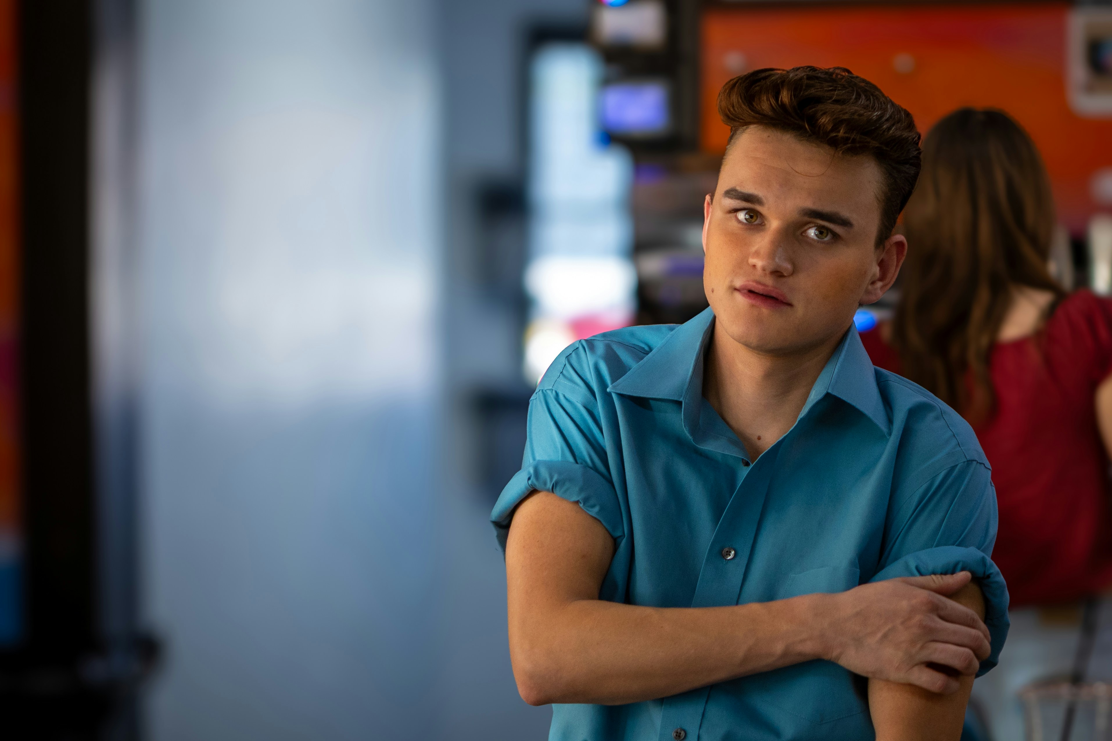 Young man in blue shirt looking at camera