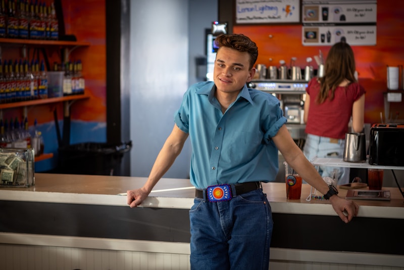 Young man in retro clothing at a counter