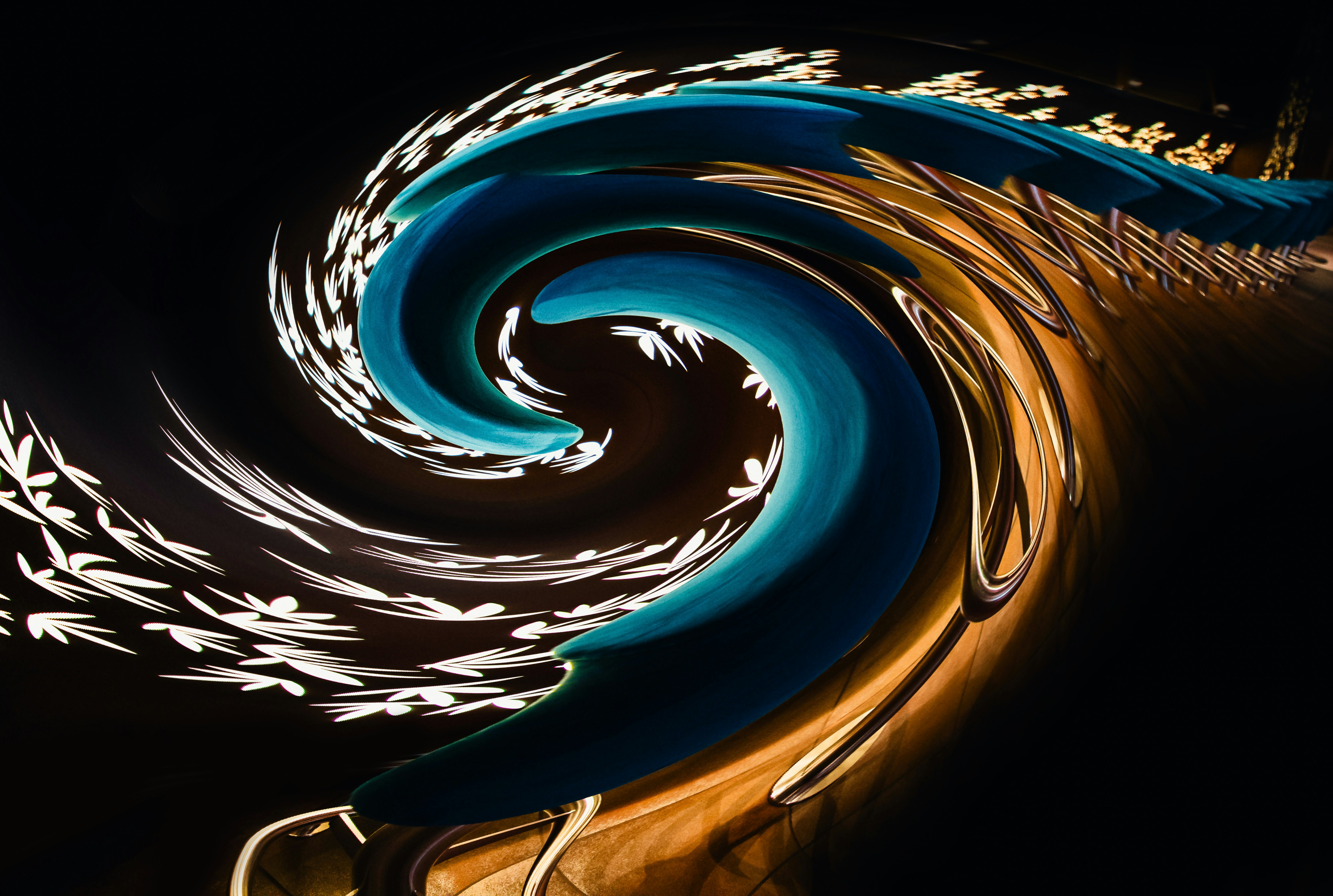 Abstract swirl of blue, white, and gold colors.