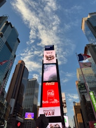 Times square billboards under a cloudy blue sky
