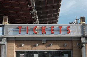 Red letters spell tickets above a building entrance