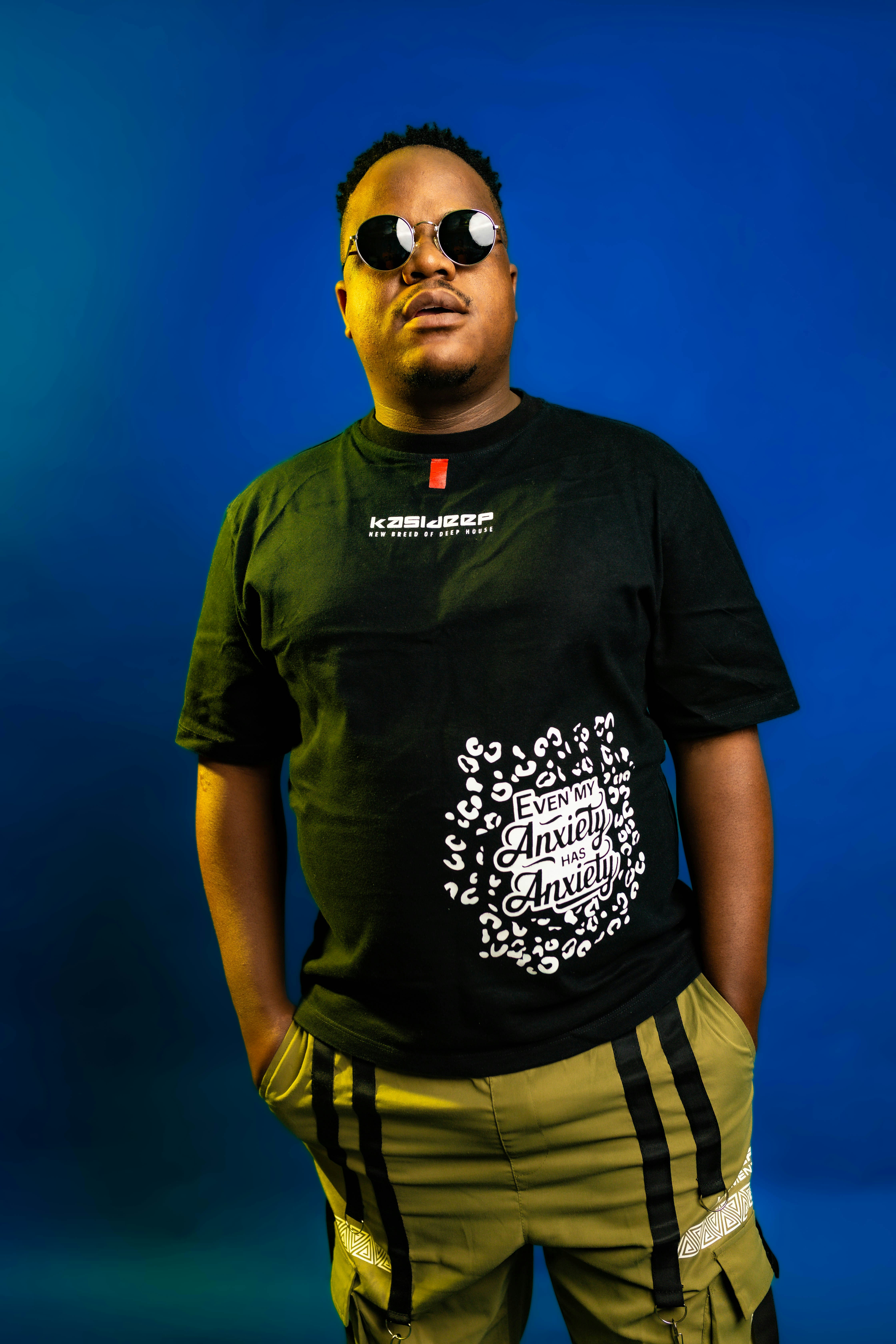 Man in sunglasses and t-shirt against blue background