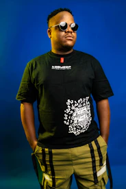 Man in black t-shirt and sunglasses posing