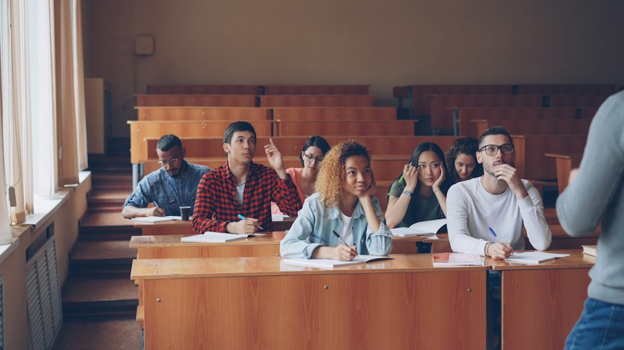 Students raising their hands in a lecture hall