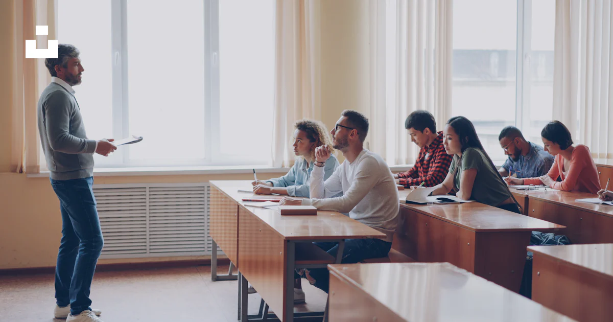 Instructing Class Teacher instructing students in a classroom lecture. photo – Free ...