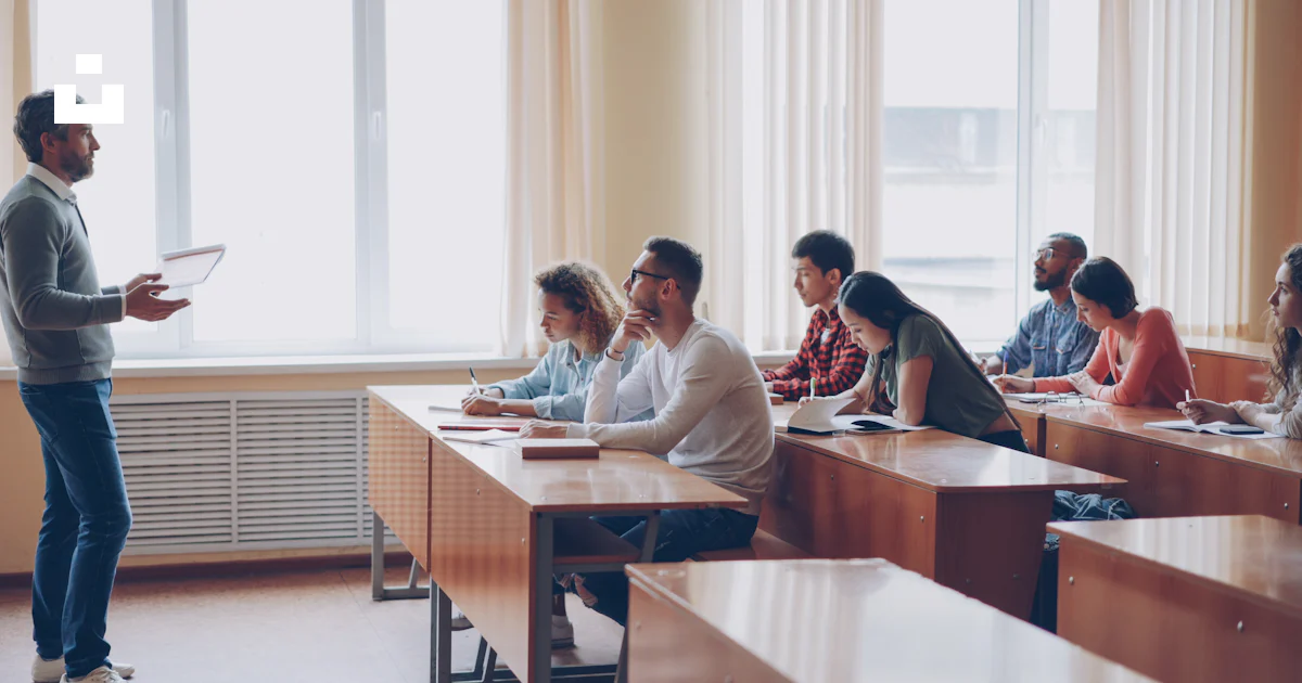 Teacher instructing students in a classroom lecture. photo – Free ...