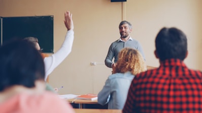 Teacher asking a question to students in a classroom.