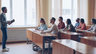 Professor lecturing to students in a classroom.