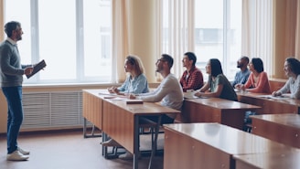 Professor lecturing to students in a classroom.