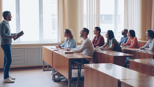 Professor lecturing to students in a classroom.