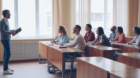 Professor lecturing to students in a classroom.