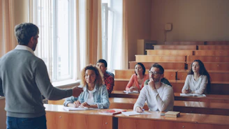 Professor lecturing to students in a lecture hall.