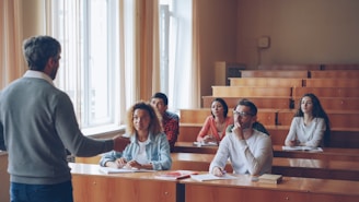 Professor lecturing to students in a lecture hall.