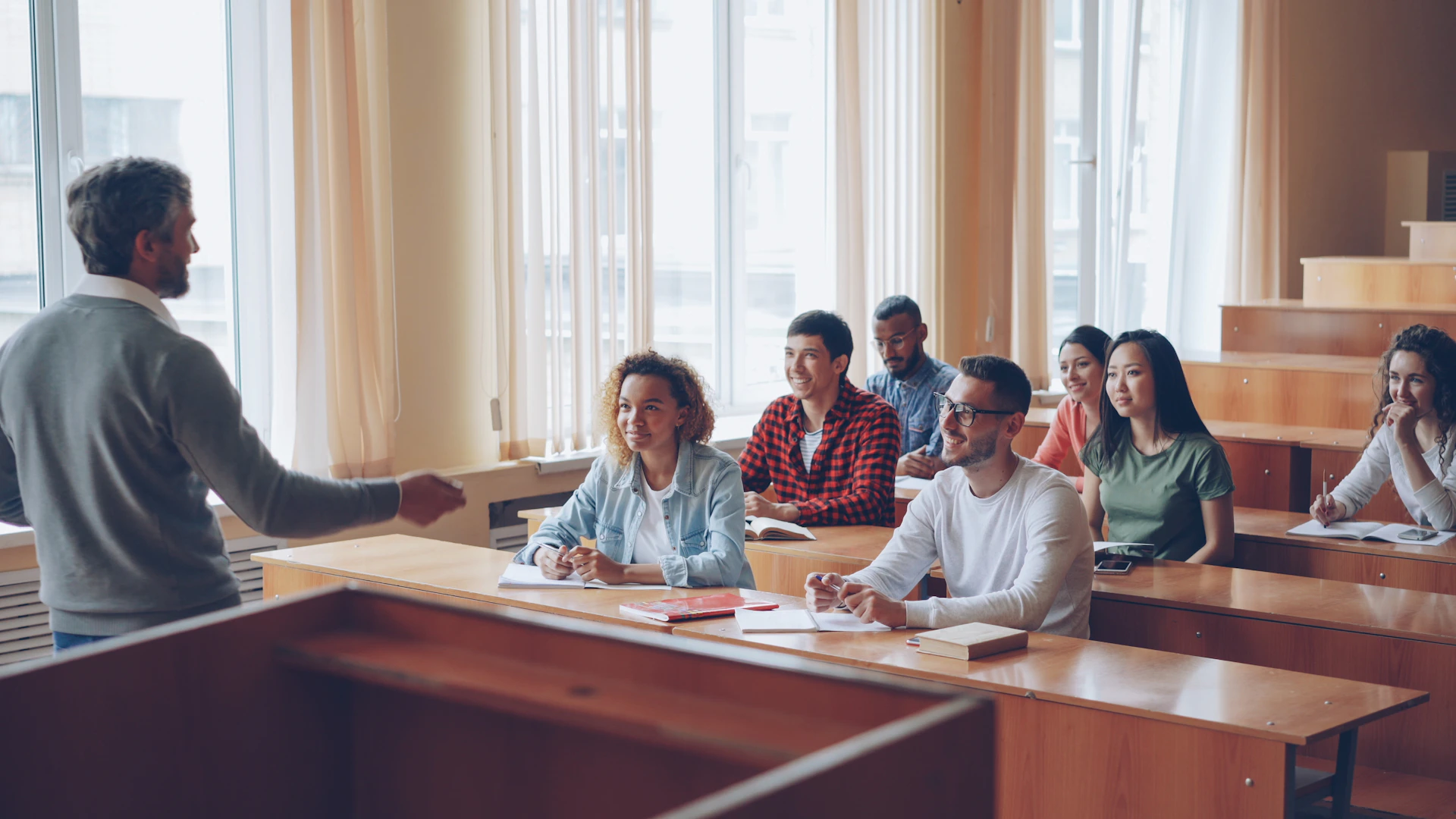 Professor teaching students in a lecture hall.