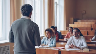 Professor teaching students in a lecture hall.
