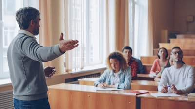 Professor lecturing to students in a lecture hall.