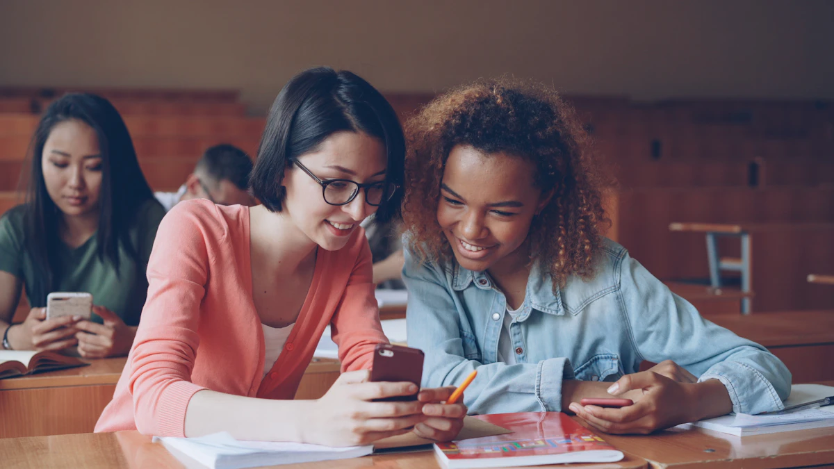 Two students booking gear on a phone