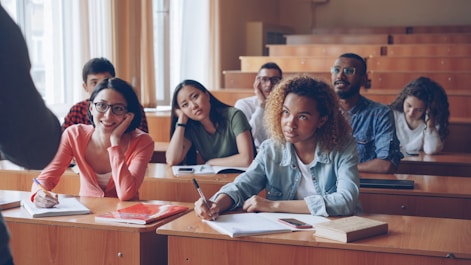 Students attentively listening in a lecture hall.