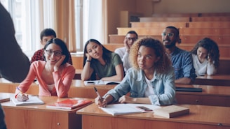 Students attentively listening in a lecture hall.