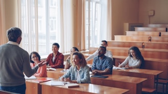 Professor teaching students in a lecture hall.