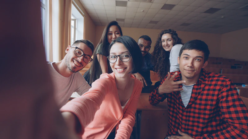 group of smiling students taking a selfie