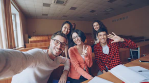Group of students taking a selfie in a classroom