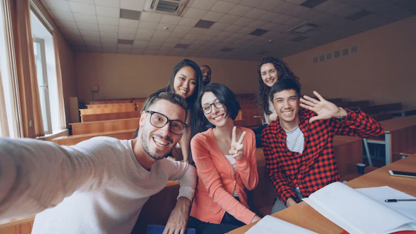 Group of students taking a selfie in a classroom