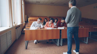 Professor teaching students in a lecture hall.