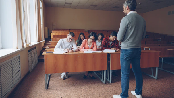 Professor teaching students in a lecture hall.