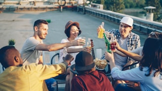 Friends enjoying drinks on a rooftop at sunset
