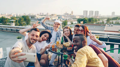 Group of friends taking a selfie on a rooftop