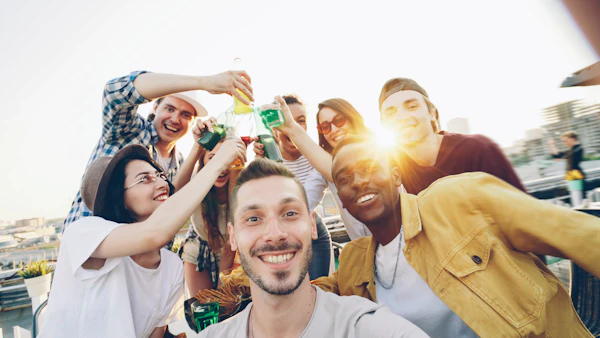 Friends toasting drinks at a rooftop celebration