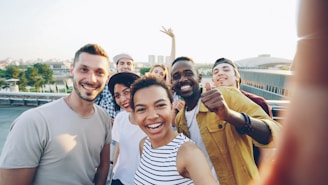 A diverse group of friends taking a selfie outdoors.