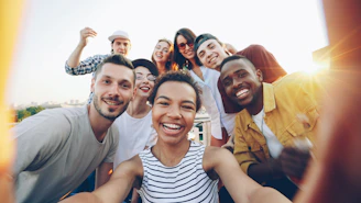 Diverse group of friends taking a selfie outdoors selfie