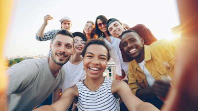 Diverse group of friends taking a selfie outdoors selfie