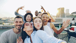 Group of friends taking a selfie on a rooftop