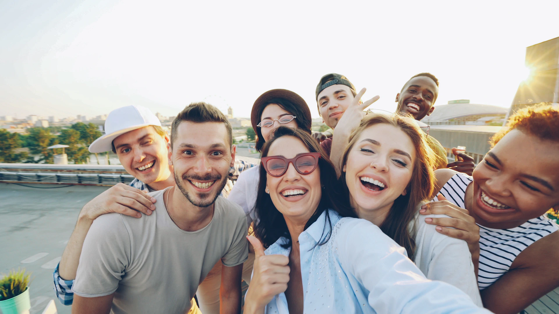 A diverse group of friends taking a selfie outdoors.
