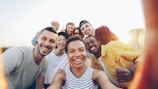 A diverse group of friends taking a selfie outdoors