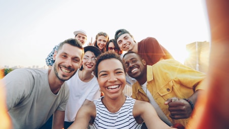 A diverse group of friends taking a selfie outdoors