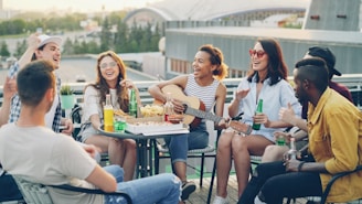 Friends enjoying a rooftop party with music and drinks.