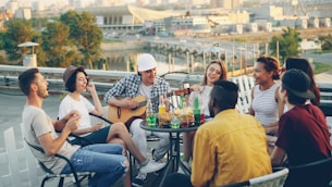Friends enjoying a rooftop gathering with music and drinks